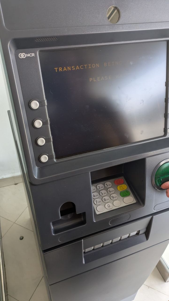 A cash machine in Mersing, mid-transaction.